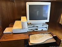 Full front view of the vintage computer setup including ViewSonic 21PS monitor on stand with floppy disk holders, APC UPS unit, and beige keyboard on a wooden desk.