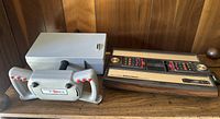 Virtual Pilot Pro controller next to Intellivision console showing overall lot contents