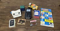 Complete lot showing all items including Walkman, View-Master, toy truck, cards, Rubik's Cube, and invisible ink pens