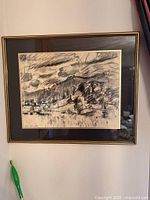 Frontal view of framed charcoal drawing showing landscape sketch and artist signature at lower left