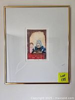 Framed etching art with gold frame and white mat board, signed and numbered artwork centered in frame with label 'Lot 135' visible.