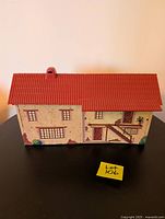 Front view of the Zorro Garrison Hacienda playset showing detailed window and stair facade with red tiled roof and chimney.