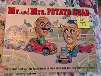 Box lid showing vintage Mr. and Mrs. Potato Head artwork with cars and trailers in countryside scenery