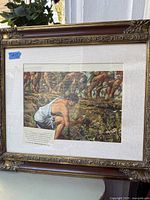 Photo of vintage print depicting a man working in a field, displayed in an ornate gilded wood frame with matting.