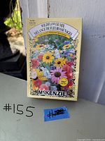 Photo of unopened McKenzie Wildflower Mix seed box with colorful wildflowers on the front and labelled 10g, 1007 seeds.