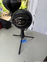 Front view of Blue Snowball iCE microphone on tripod stand showing Blue logo on mesh grille.