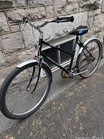 Front side view of bicycle showing black frame and silver fender