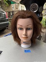 Front view showing facial features and hair style