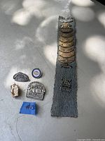 Overview of Harley Davidson pins with denim strips and individual pins laid out, showing variety and quantity.