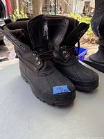 Pair of Timberline Kodiak men's winter boots in black, size 9, showing full side and front view with laces tied.