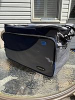 Side view of the insulated cooler bag showing front zippered pocket and North 49 logo.