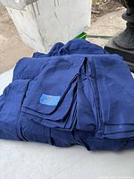 Blue queen size sheet set folded neatly including top sheet, fitted sheet, and two pillowcases.