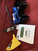 Set showing the digital tire pressure gauge with flexible probe, yellow transmission funnel, blue strap, and boxed three-pack of Greenwills Extension Cord Safety Seal