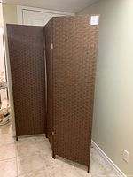 Full view of the privacy screen standing unfolded in a room, showcasing its height and three-panel fold design.