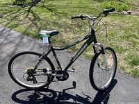 Full view of the green Schwinn Soto AluLite men's bicycle showing frame, tires, and handlebars.