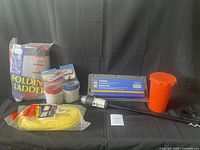 Full view of boating accessories including ladder, drink holders, squeegee, rope, bucket, and boat light