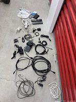 Wide view showing all items laid out including cables, power adapters, remotes, and small connectors