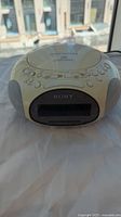 Sony Dream Machine off-white clock radio CD player model ICF-CD831 showing top control buttons, brand name on front, and built-in speakers on sides.