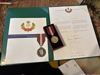 Overview of the medal, literature folder and official letter highlighting the 60th anniversary of Queen Elizabeth II's ascension.