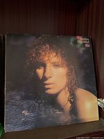 Close-up of 'Wet' album by Barbra Streisand showing album cover art with portrait of the artist in water.