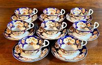 Set of 8 Royal Albert 'Derby / Heirloom' teacups with matching saucers arranged together showing full set
