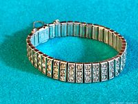 Full view of the vintage sterling silver bracelet showcasing rhinestone segments and flexible width.