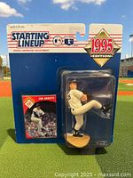 Photo showing Jim Abbott 1995 Edition Starting Lineup figure in original blister card packaging with visible collectible card and baseball action pose.