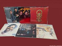 All 6 vinyl records arranged with front covers visible on a dark surface, showing full cover art and condition.