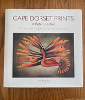 Front cover of 'Cape Dorset Prints: A Retrospective' hardcover book showing bird artwork.