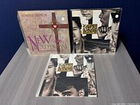 Three vinyl records: New Gold Dream and two copies of Once Upon a Time by Simple Minds on a tabletop