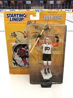 Front photo of Eric Lindros Starting Lineup 1998 action figure in original sealed packaging, showing figure and included trading card.