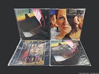 Four Styx vinyl records laid out on the floor showing front cover artwork for Cornerstone, Pieces of Eight, and Grand Illusion albums. Two copies of Cornerstone included.