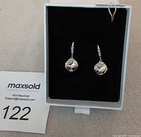 Pair of drop earrings with clear Swarovski crystals displayed in white jewelry box with black velvet insert.