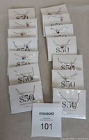 Photo showing 14 packaged Effy Swarovski crystal necklaces each with pendant in different crystal colors arranged on a surface.