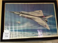 Framed poster of an Avro Arrow aircraft, black frame with a gold inner edge. Poster shows rippled texture due to humidity.