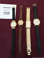 Four ladies wristwatches laid out flat showing straps and faces to display condition and variety