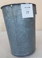 Side view of galvanized metal bucket with MaxSold tag indicating lot number 77.