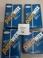 Four packages of paraffin wax arranged in two rows showing brand and product information.