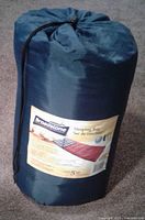 Sleeping bag in dark blue storage sack with label showing Broadstone brand and sleeping temperature rating to -5°C.