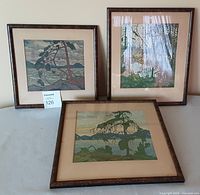 Three framed landscape prints shown together on a table, titles and frame sizes visible, wood frames, mats aged.