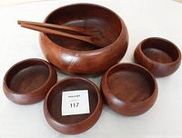 Complete set of vintage teak wooden bowls and tongs displayed on a white surface.
