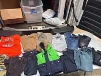 Photo showing 13 boys clothing items including hoodies, jackets, jeans, pants, and sweaters in various colors and styles.
