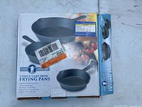 Box of 3 Piece Cast Iron Frying Pans showing brand Ship Shape and sizes of pans included.