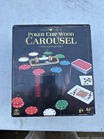 Box front showing the product name and image of the wooden poker chip carousel with chips and cards.