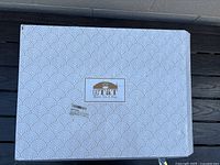 Closed box with Brew At logo on lid and decorative pattern