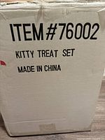 Box showing the label 'Kitty Treat Set Made in China' indicating set contents and origin