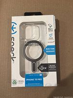 Front view of clear phone case packaging showing branding, MagSafe compatibility, 13 ft drop tested, Microban antimicrobial, and no-slip interlock design.