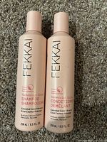 Photo showing the front labels of two pink sealed bottles of Fekkai shampoo and conditioner for color-treated hair, each 8.5 fl oz.