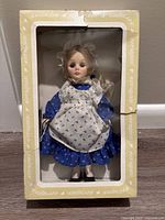 Little Miss Muffet Effanbee doll in original beige box, front view showing doll through window display with original packaging.