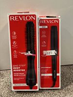 Both hair styling tools, boxed, showing fronts of the boxes with product names and images.
